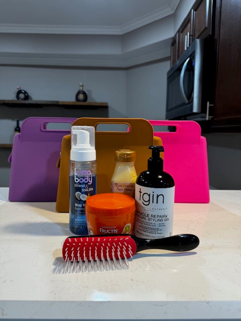 IMAGE OF THE XL(SUPREME) IBIG SILICONE MAKEUP BAGS IN FUSCHIA PINK, PURPLE AND BROWN WITH HAIRCARE PRODUCTS AND A DENMAN BRUWSH ARRANGED IN FRONT OF THEMTravel makeup bag / travelbag / travel bags for women / toiletry travel bag / travelbags / cosmetic bags/beauty bag/ makeup / makeup organizer